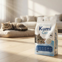 Kumi Cat Aktif Karbonlu Bentonit Kedi Kumu 10 L, yaşam alanında paket ve arka planda uyuyan kedi